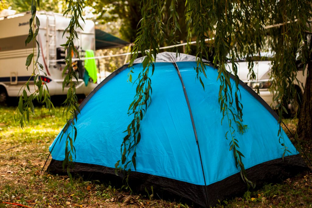 blue-tent-shadow-tree-camping